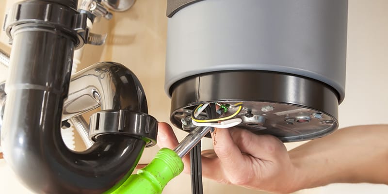 Boynton Beach, Florida plumber servicing water heater pipe connection