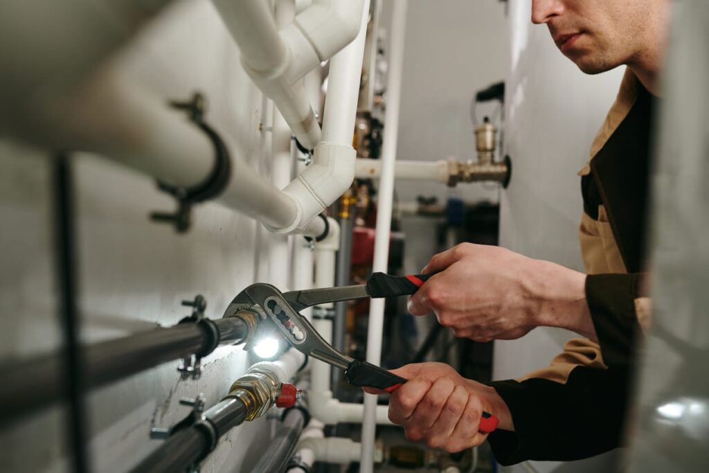 Plumbers maintaining commercial plumbing pipes in Boynton Beach